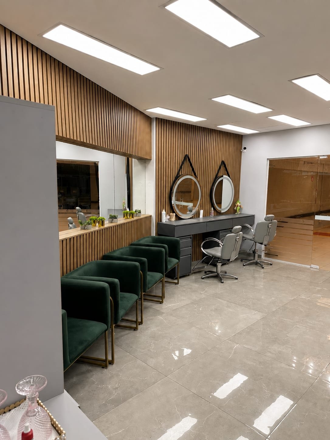 Estação de corte com painel de madeira ripada e espelhos redondos